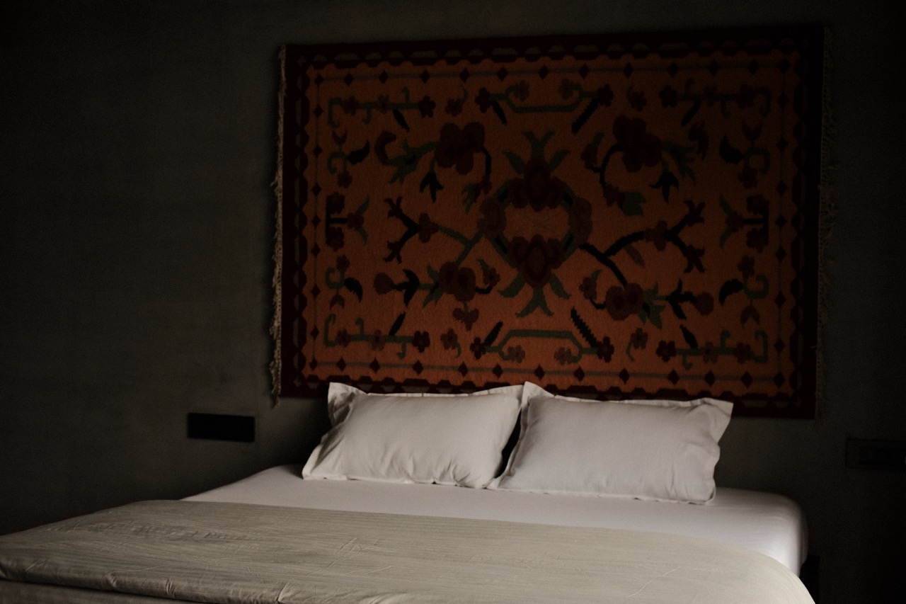 Close view of the woven kilim above crisp white pillows