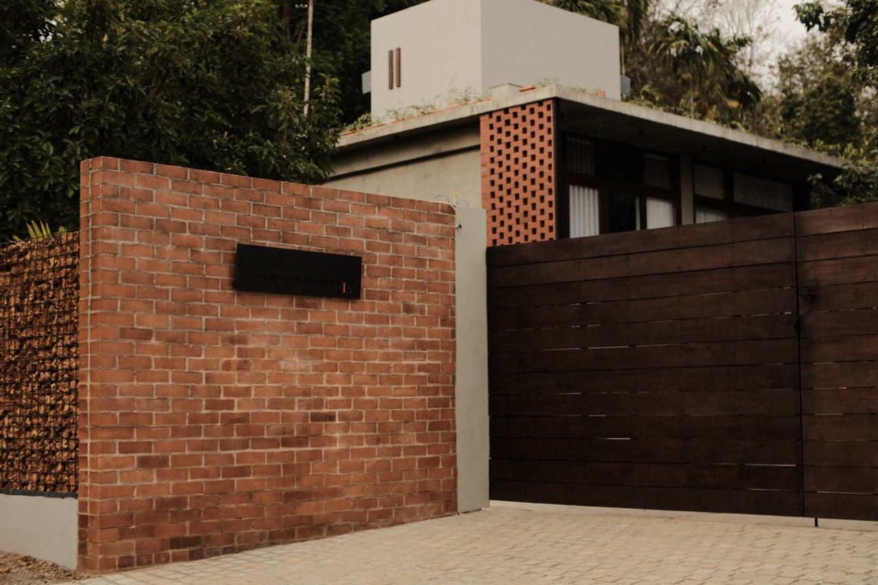 The brick entrance wall and timber gate at the road approach