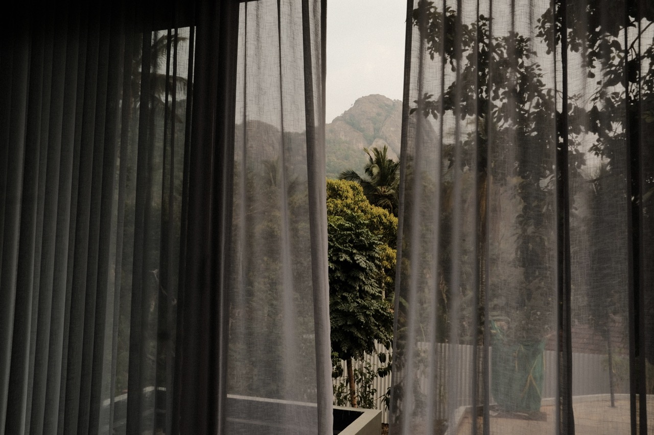 The Edakkal Hills seen through sheer curtains from inside the house